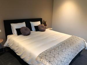 a bed with two pillows on it in a bedroom at Huis Berenbroek in Genk