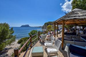 a group of people sitting in chairs on a beach at Villa La Buena Vida in Benissa