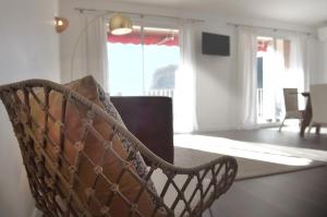 a chair in a room with a living room at LA FALAISE PARADIS Vue mer 180° in Cassis