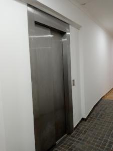 an elevator door in an office building at Hotel Silver Golf in Sierra de la Ventana
