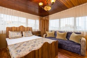 a bedroom with a large bed and a couch at Kervanchi in Istanbul
