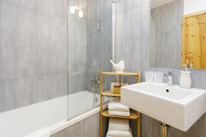 a bathroom with a sink and a shower at Amazing Rooftop Terrace With River And Historic City View 4 Bedrooms 4 bathrooms AC 19th Century Building Chiado in Lisbon