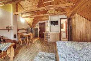 a room with a bed and a kitchen with a table at ZET - Penzion & Wellness in Vyšné Ružbachy