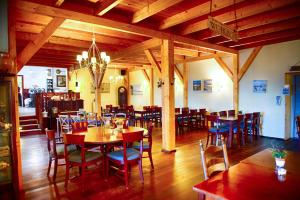 Insel-Land-Hotel Michaelsen في بوركوم: غرفة طعام بها طاولات وكراسي وثريا