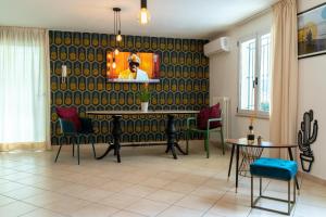 a living room with a tv on a wall at Residence l'Appartamento in Rimini