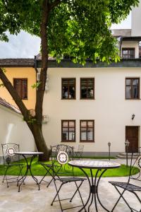 a group of tables and chairs in front of a building at P&J Holiday Houses in Krakow