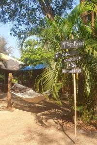 a hammock and a sign in front of a resort at Palm Forest Palolem in Palolem