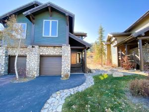 a house with a garage and a driveway at Snowcreek V #774 condo in Mammoth Lakes