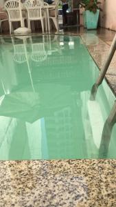 a glass table with chairs on top of it at Hostel Icaraí Inn in Niterói