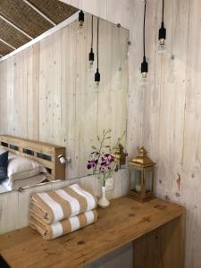 a room with a table with towels and a bed at Palm Forest Palolem in Palolem