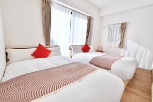 Postel nebo postele na pokoji v ubytování Riverside Inn Hakata