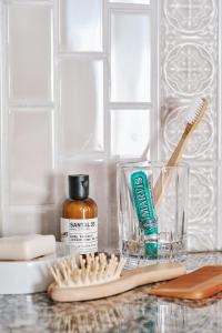 a counter with a toothbrush and a bottle of toothpaste at El Llorenc Parc de la Mar - Adults Only (+16) in Palma de Mallorca