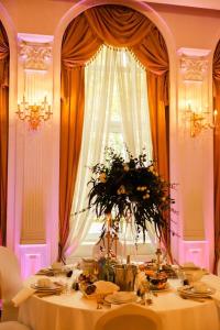 a table with a vase of flowers on it at Hotel Holiday Park in Warsaw