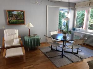 a living room with a dining room table and chairs at Haus-Muehlenpark in Wyk auf Föhr