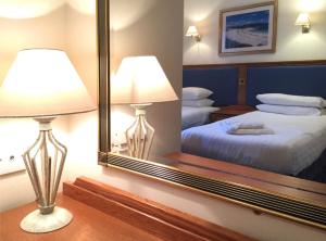 A bed or beds in a room at Glen Nevis Holidays 