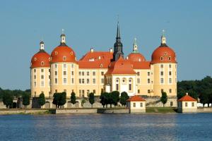 a large building with red domes on top of the water at Ferienwohnung Elbe in Kurort Gohrisch