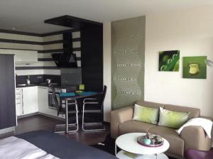 a living room with a couch and a kitchen at Encore-ONE in Büsum