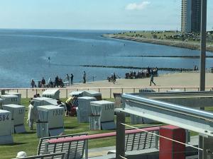 a view of a beach with people and the ocean at Encore-ONE in Büsum