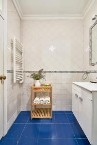 a bathroom with a blue tiled floor and a sink at Spacious Bairro Alto Apartment With Courtyard, By TimeCooler in Lisbon