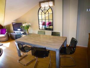 a dining room with a wooden table and chairs at Apartamentos Formigal - admite mascotas in Formigal