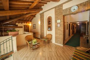 an open living room with a clock on the wall at Hotel Corte Vecchia in San Prospero 