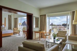a hotel room with a living room with a view at Steigenberger Pyramids Cairo in Cairo