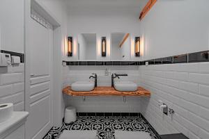 a white bathroom with two sinks and a mirror at Rezidence Znojmo SPA Privat wellness in Znojmo +207 photos