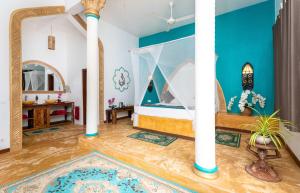 a room with blue walls and a room with a bed at Kibanda Natural Kendwa Villa in Kendwa +161 photos