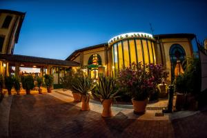 a building with potted plants in front of it at Hotel Corte Vecchia in San Prospero 