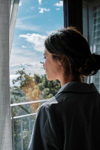a woman looking out of a window at El Llorenc Parc de la Mar - Adults Only (+16) in Palma de Mallorca