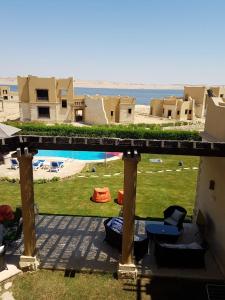 a view from the balcony of a house with a pool at Byoum Vacation House in Fayoum