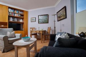 a living room with a couch and a table at Appartement-Jeanette in Westerland