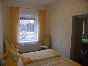 a small bedroom with two beds and a window at Ferienwohnung-Familie-Hempel in Hohendorf