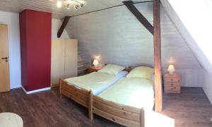 a bedroom with a wooden bed in a attic at Altes-Landhaus-Ferienwohnung-Schleswig-Holstein in Wendtorf