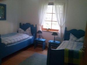a bedroom with two beds and a window at Waldhaeuschen in Bad Sachsa