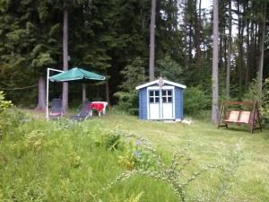 a small blue shed in the middle of a field at Waldhaeuschen in Bad Sachsa