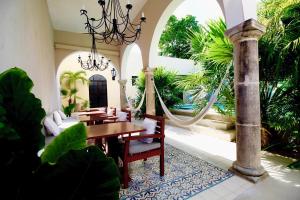 a dining room with a table and chairs at The Diplomat Boutique Hotel in Mérida