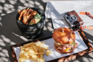 a camera taking a picture of a sandwich and chips at El Llorenc Parc de la Mar - Adults Only (+16) in Palma de Mallorca