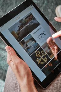 a person holding a ipad with a website at El Llorenc Parc de la Mar - Adults Only (+16) in Palma de Mallorca