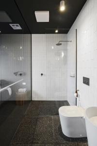a bathroom with a shower and a toilet and a sink at Months and Seasons - Momentary Escapes - Coastal House in Wye River