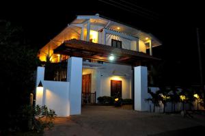 a white house at night with lights at London Palace in Anuradhapura