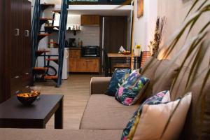 a living room with a couch and a table at Στούντιο στο κέντρο της πόλης. in Volos