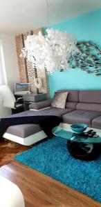 a living room with a couch and a table at Design apartment MM in Poprad