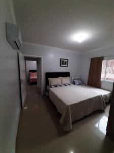 een slaapkamer met een groot bed en een raam bij APT 403 - Localização excelente Thermas Palace !! in Piratuba