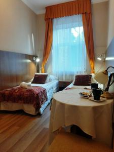 a hotel room with two beds and a window at Red Carpet Hostel in Krakow