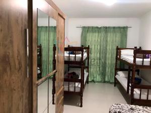 a room with two bunk beds and a window at Casa Walter in Balneário Camboriú