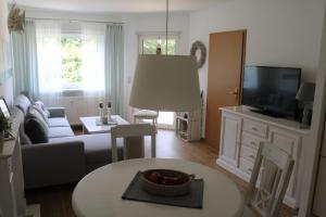 a living room with a couch and a table at Ferienwohnung-Moorberg-mit-schoener-Terrasse-in-ruhiger-Lage in Dreschvitz