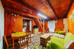 a living room with a table and a couch at Cabana Mihai in Sovata
