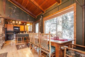 a dining room with a table and a kitchen at Treehouse On The Stream Sundance, Utah in Sundance