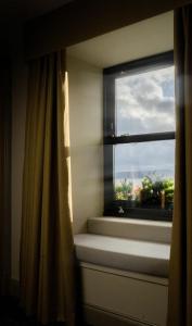 a window with a curtain and a window sill at Riva Boutique Hotel in Helensburgh